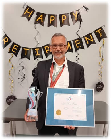 Denis Fortier holding the Physician Emeritus Award and certificate