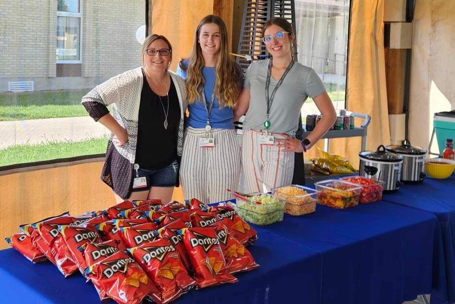 Teresa Massinon, Jayde Jonasson and Kenzie Dupasquier standing behind the taco salad bar