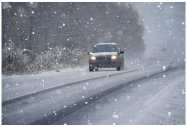 car driving through a winter storm